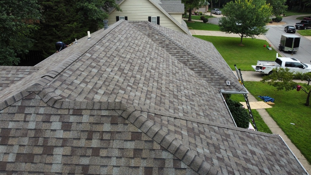 Residential tear-off in progress — old shingles stripped